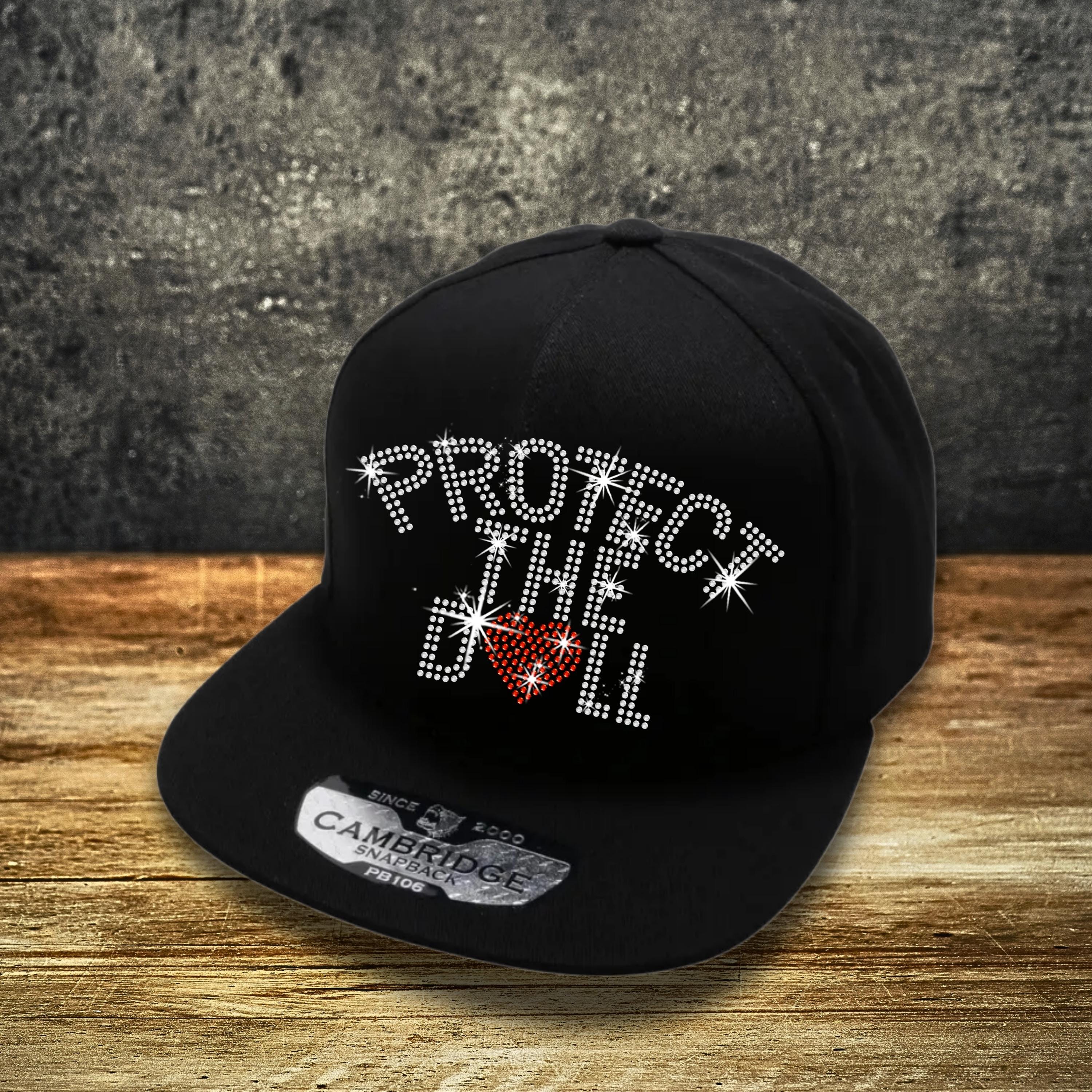 Protect The Dolls Rhinestone Snapback: Feminist Trucker Hat