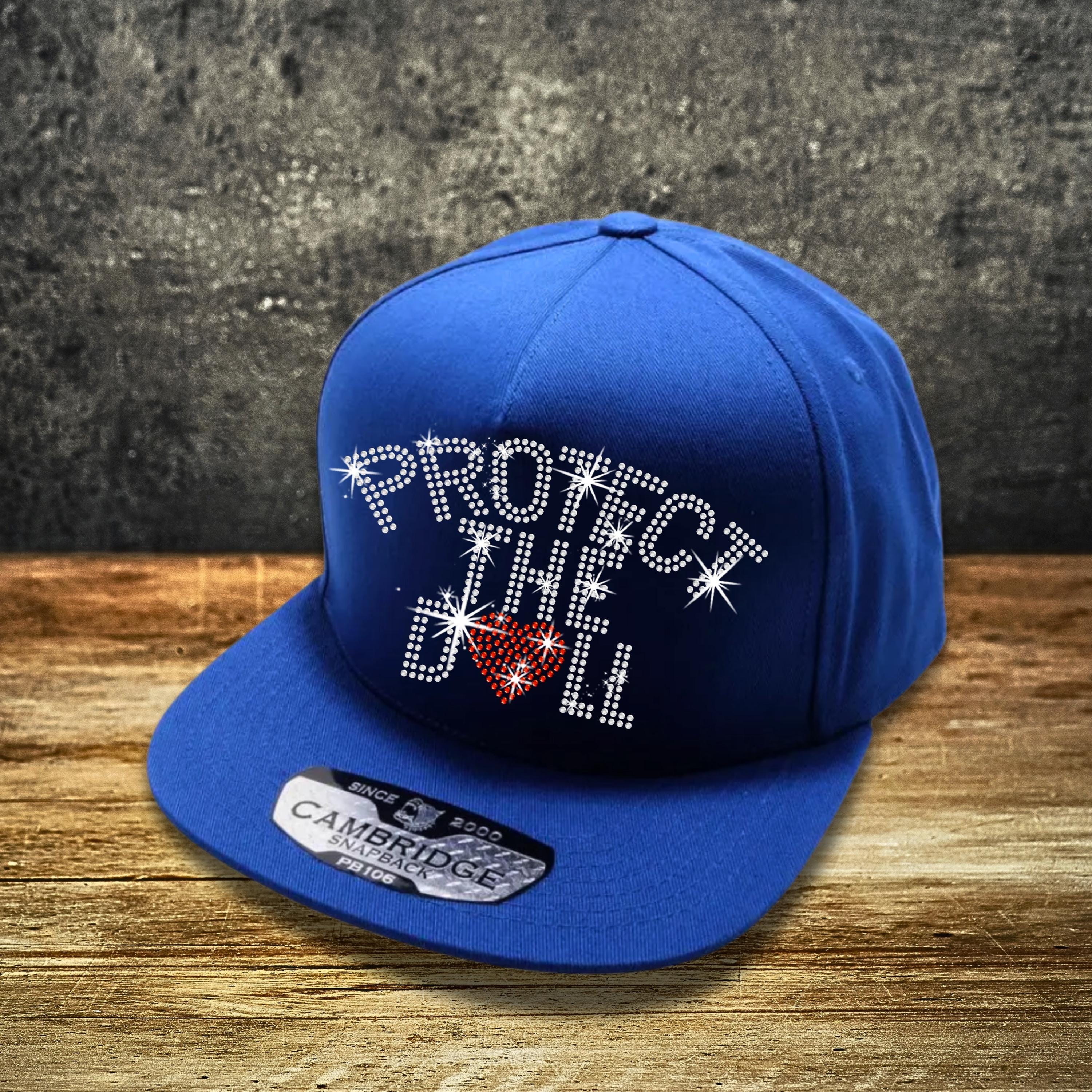 Protect The Dolls Rhinestone Snapback: Feminist Trucker Hat